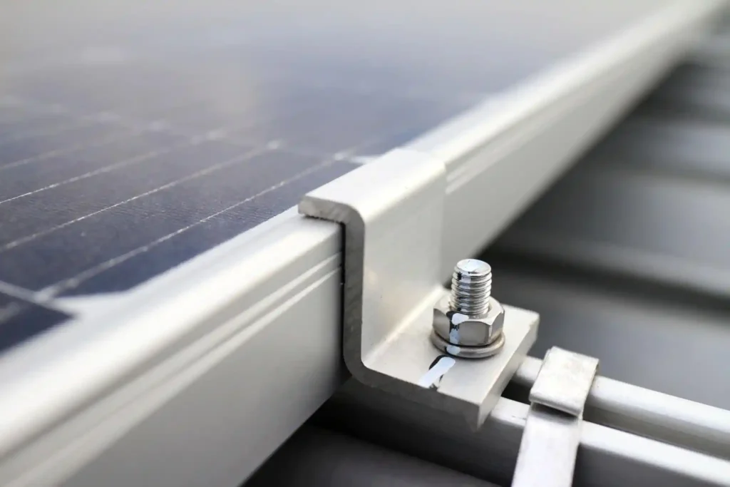 Semi-flexible solar panel mounted flush on a curved substrate beside a rigid panel installed on raised metal mounting rails